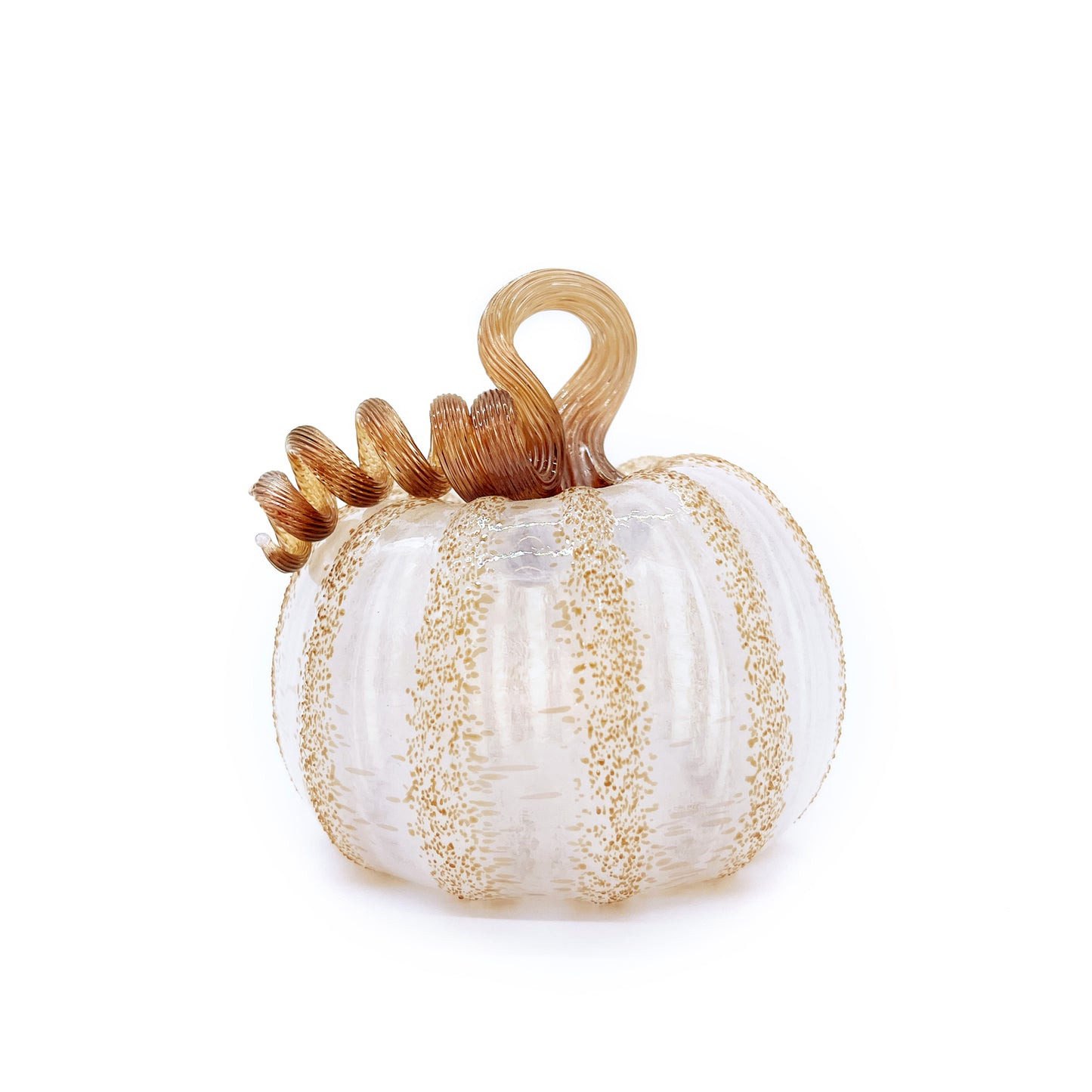 A white and gold handblown glass pumpkin against a white background.  